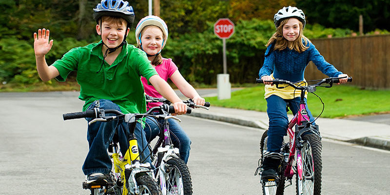 Safe-street-with-kids-riding-bicycles Kids riding bicycles on safe street